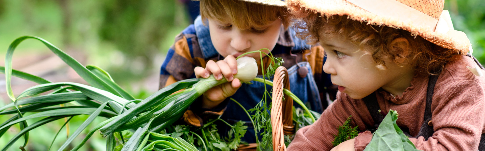 Children with a basket full of vegetables.